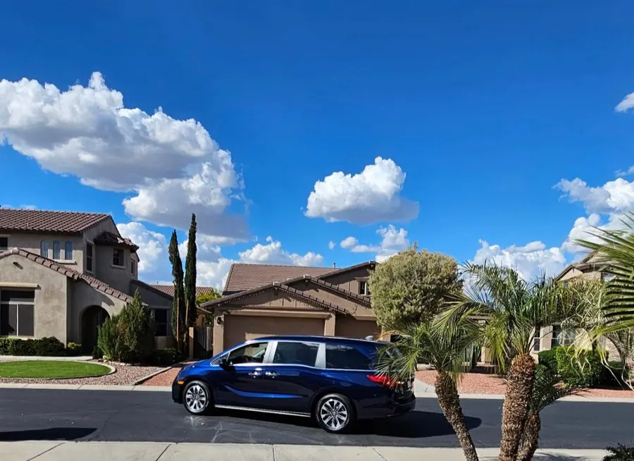 Blue Honda Odyssey delivered to a client's home