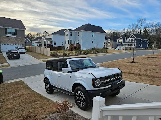 White Ford Bronco on the client's driveway