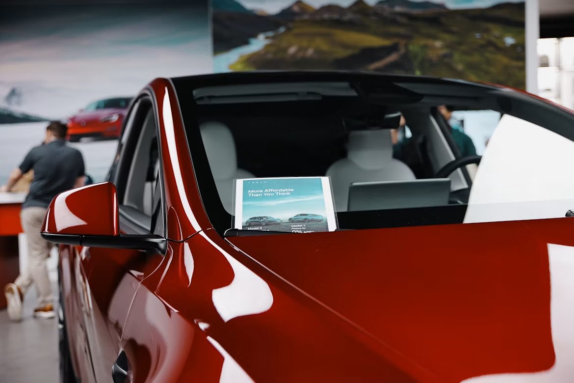 A buyer completing vehicle registration paperwork after purchase