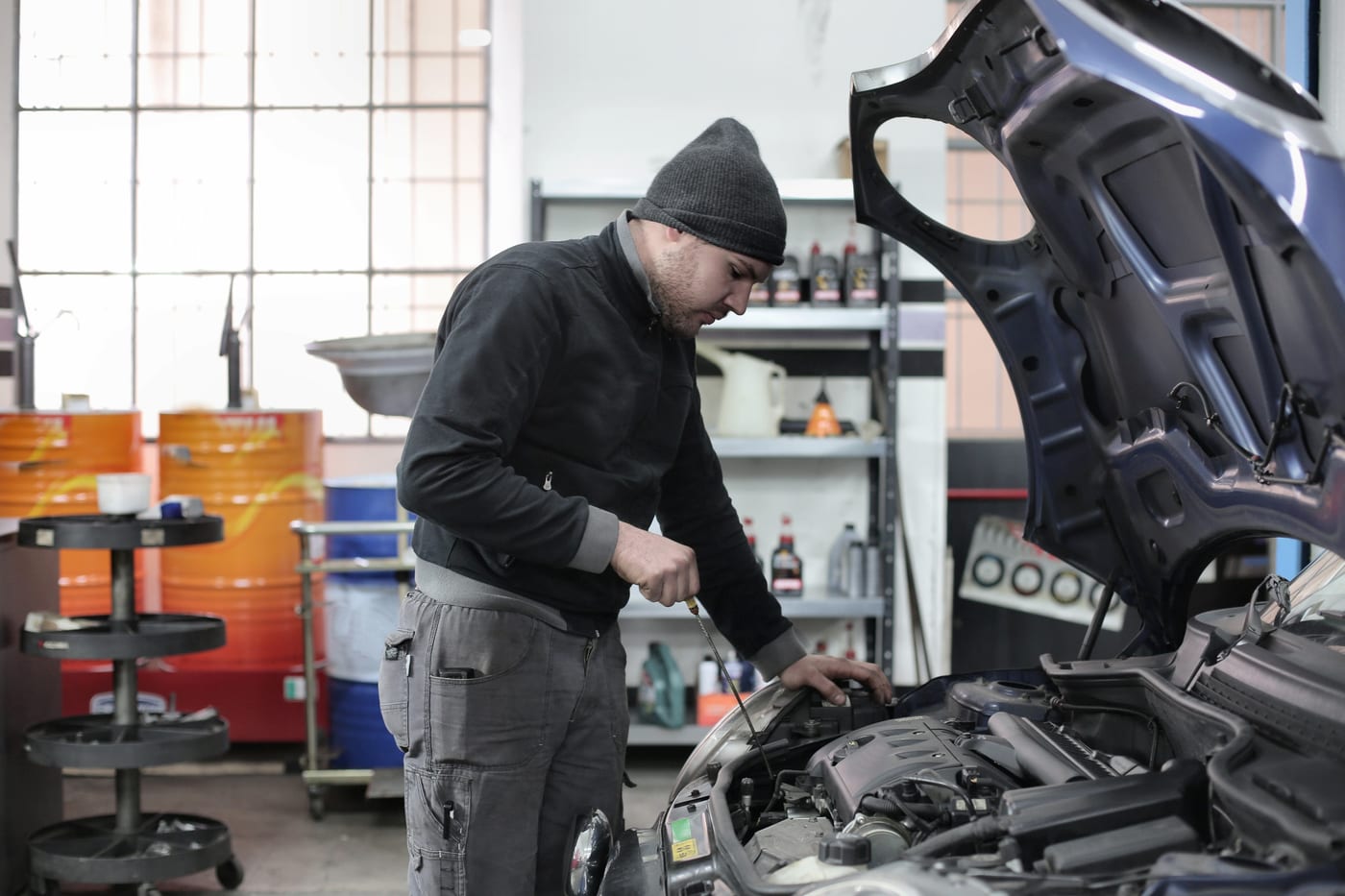 An open engine bay being inspected before a used car purchase