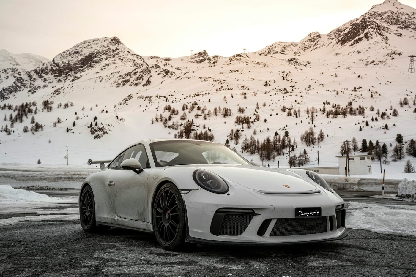 A Porsche on a workshop lift during specialist service