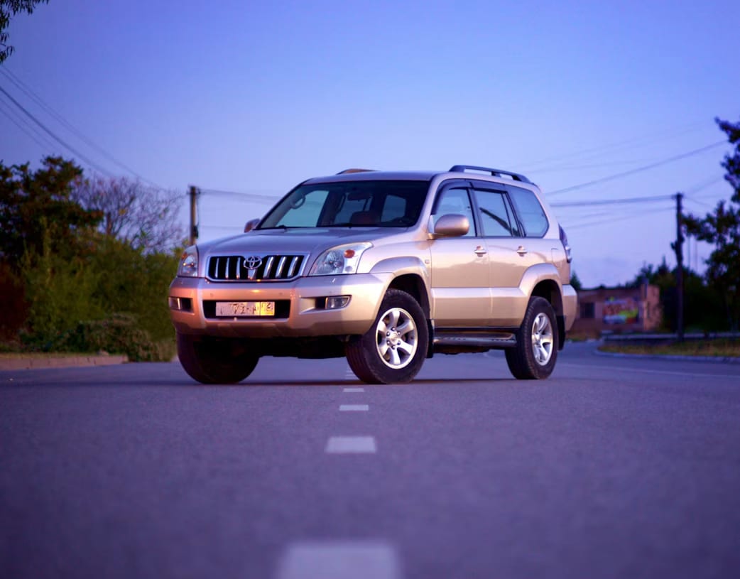 A white SUV on a road during daytime